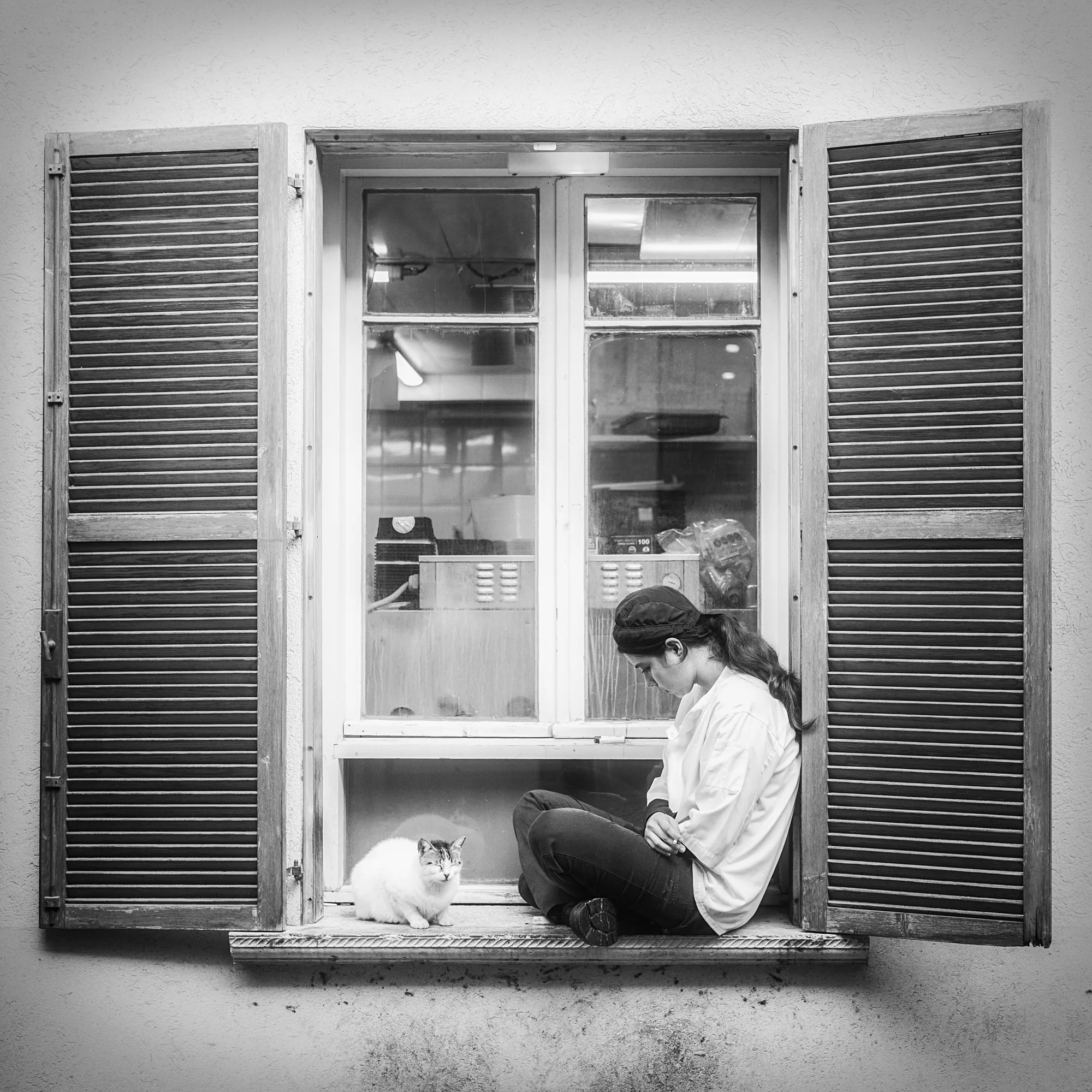Man at work, seen through shutters